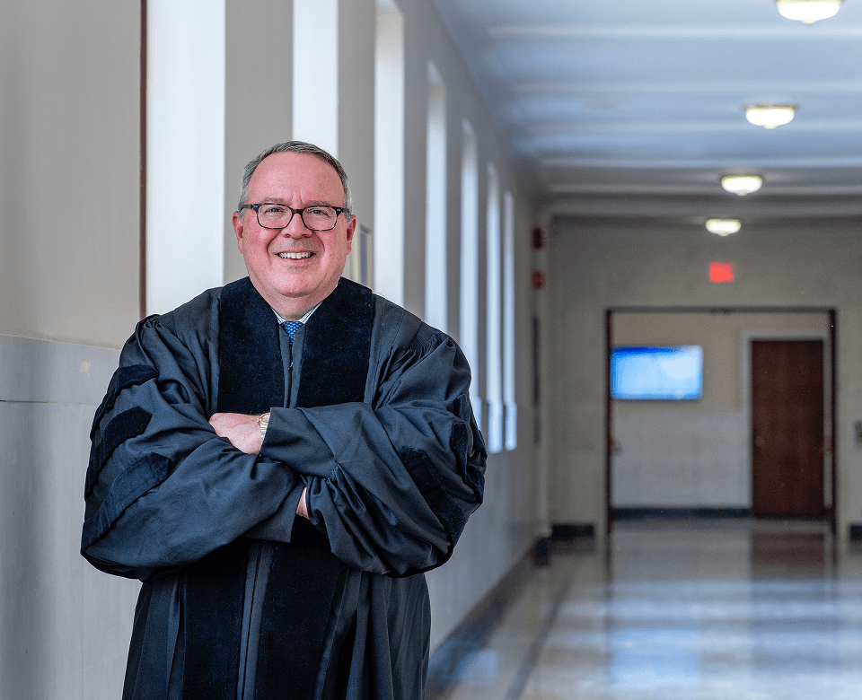 Courthouse corridor with smiling judge